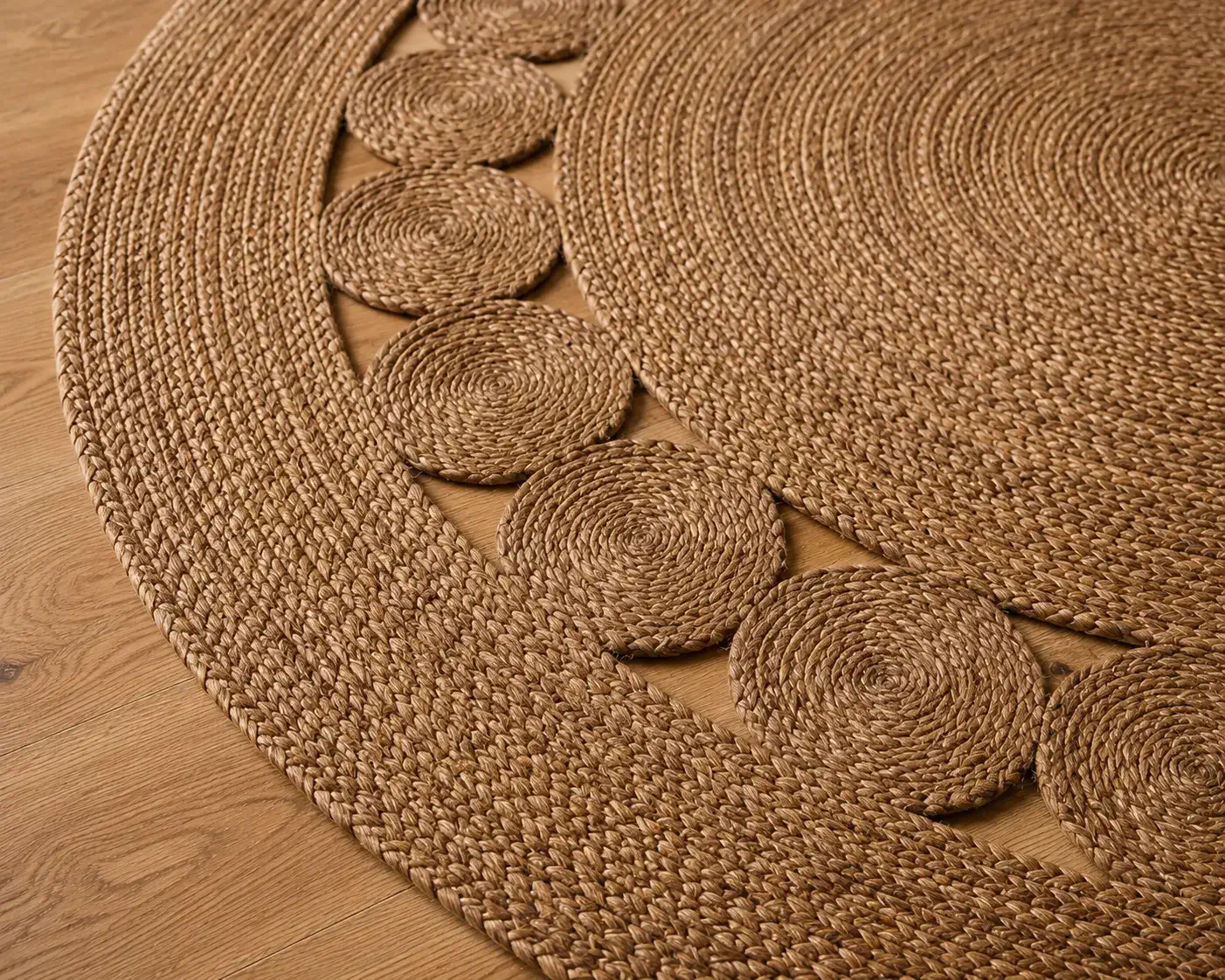 Close-up detail of the Daaira round braided jute rug showcasing handcrafted concentric braid construction, natural fibre texture, and artisanal craftsmanship by Planet Arts.
