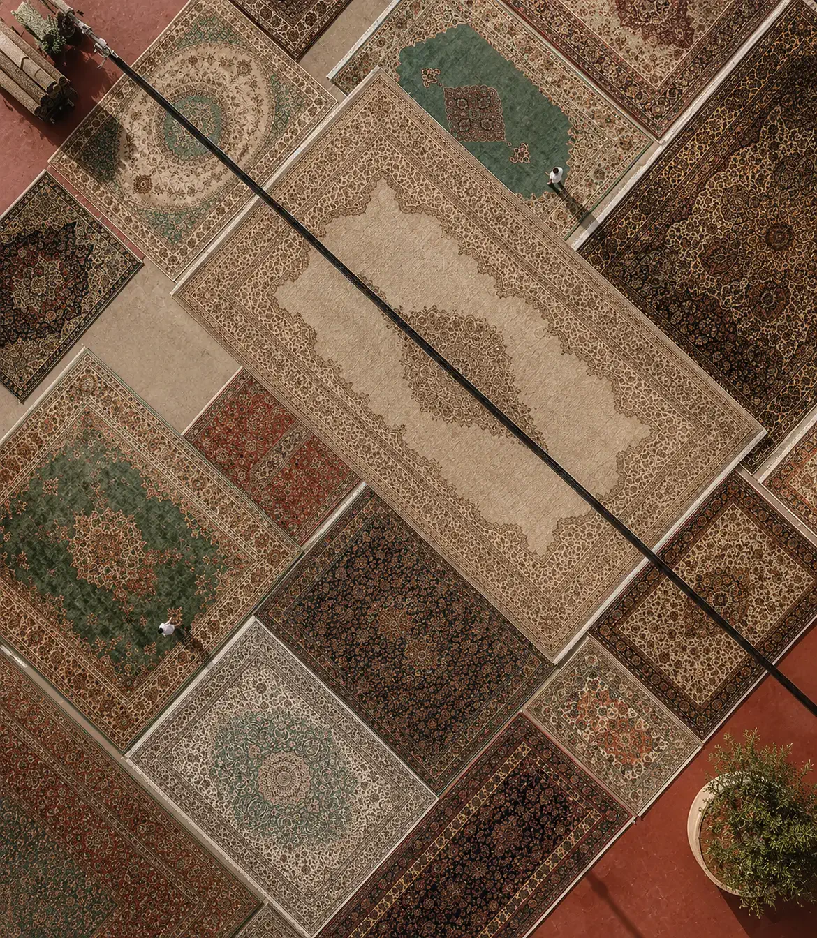 Artisan hand-braiding the Daaira jute rug